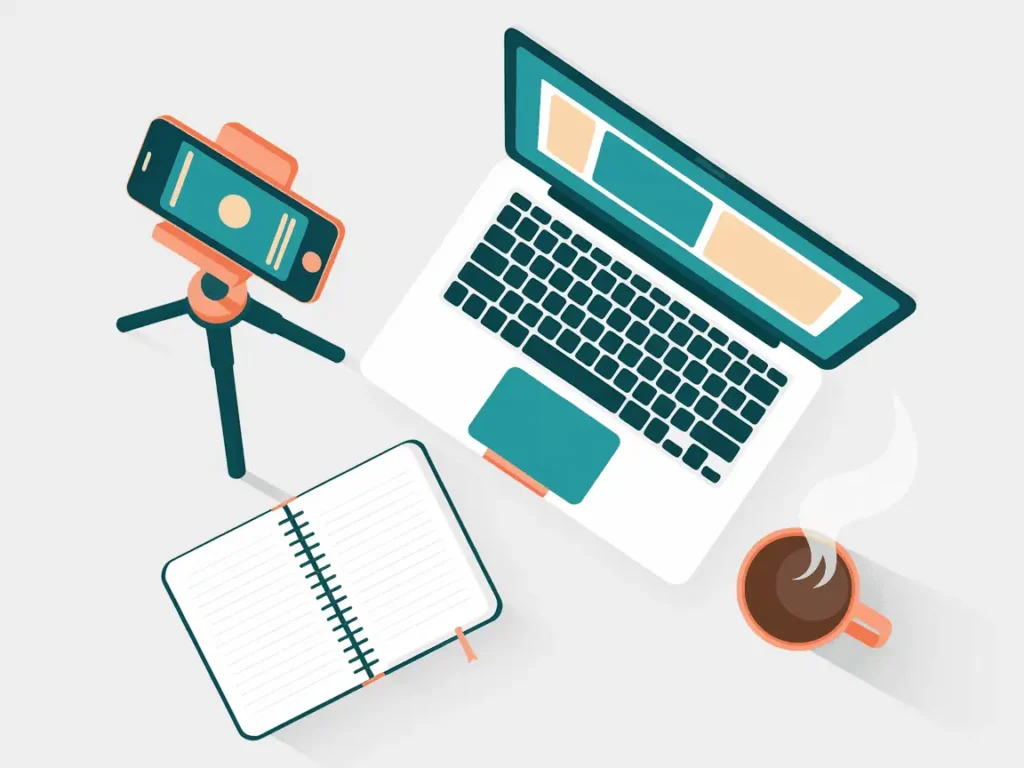 How to monetize educational videos on YouTube: Overhead view of a teacher's workspace with laptop, phone tripod, notebook, and coffee.
