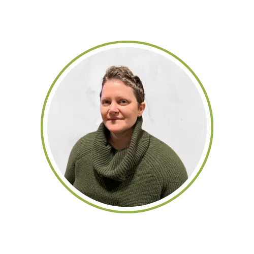 Home 5 Eileen Guevara, woman in green sweater against grey background